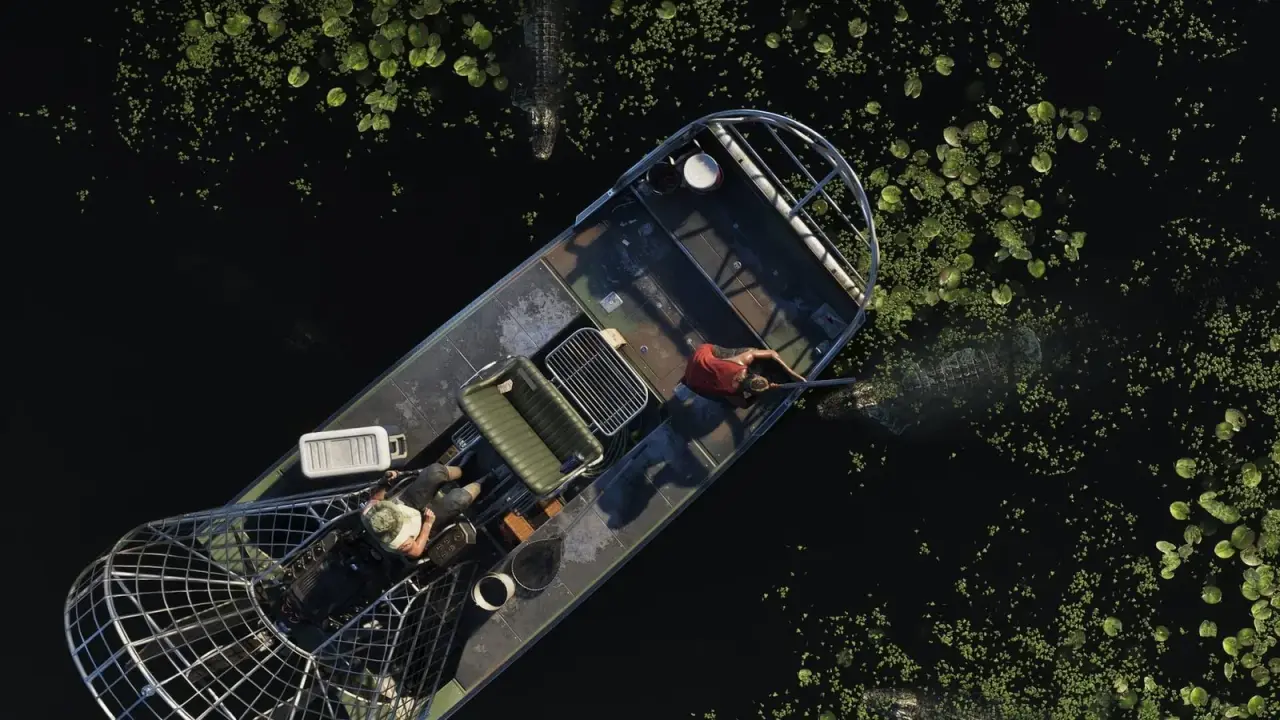 Overhead view of a GTA 6 Airboat 09 crossing a swamp covered in water plants